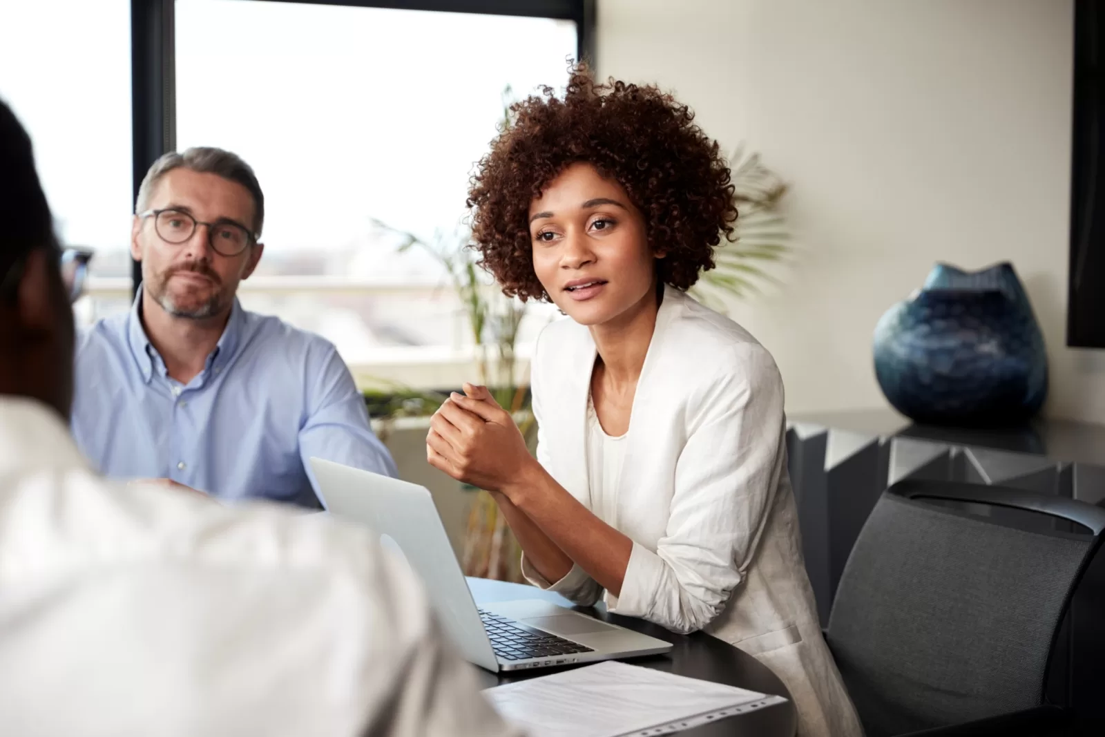 millennial-black-businesswoman-listening-to-collea-GQZCD39-1-scaled-e1615897455307-jpg.webp